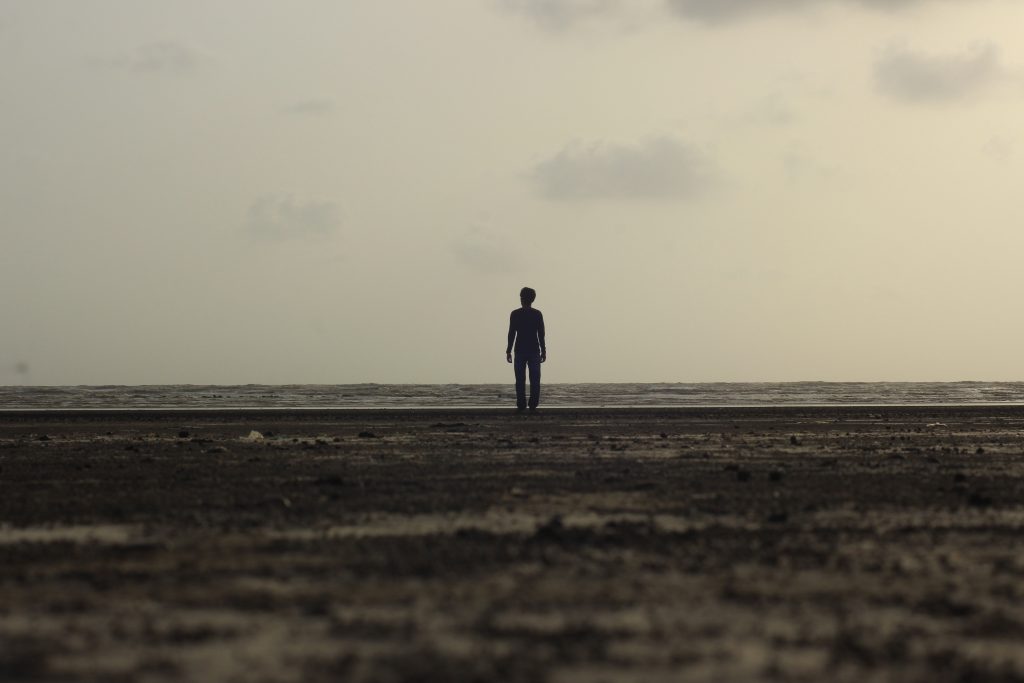 man standing on horizon in the distance