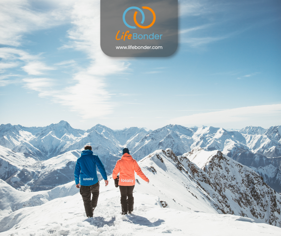 Two people travelling in the snow-covered mountains.