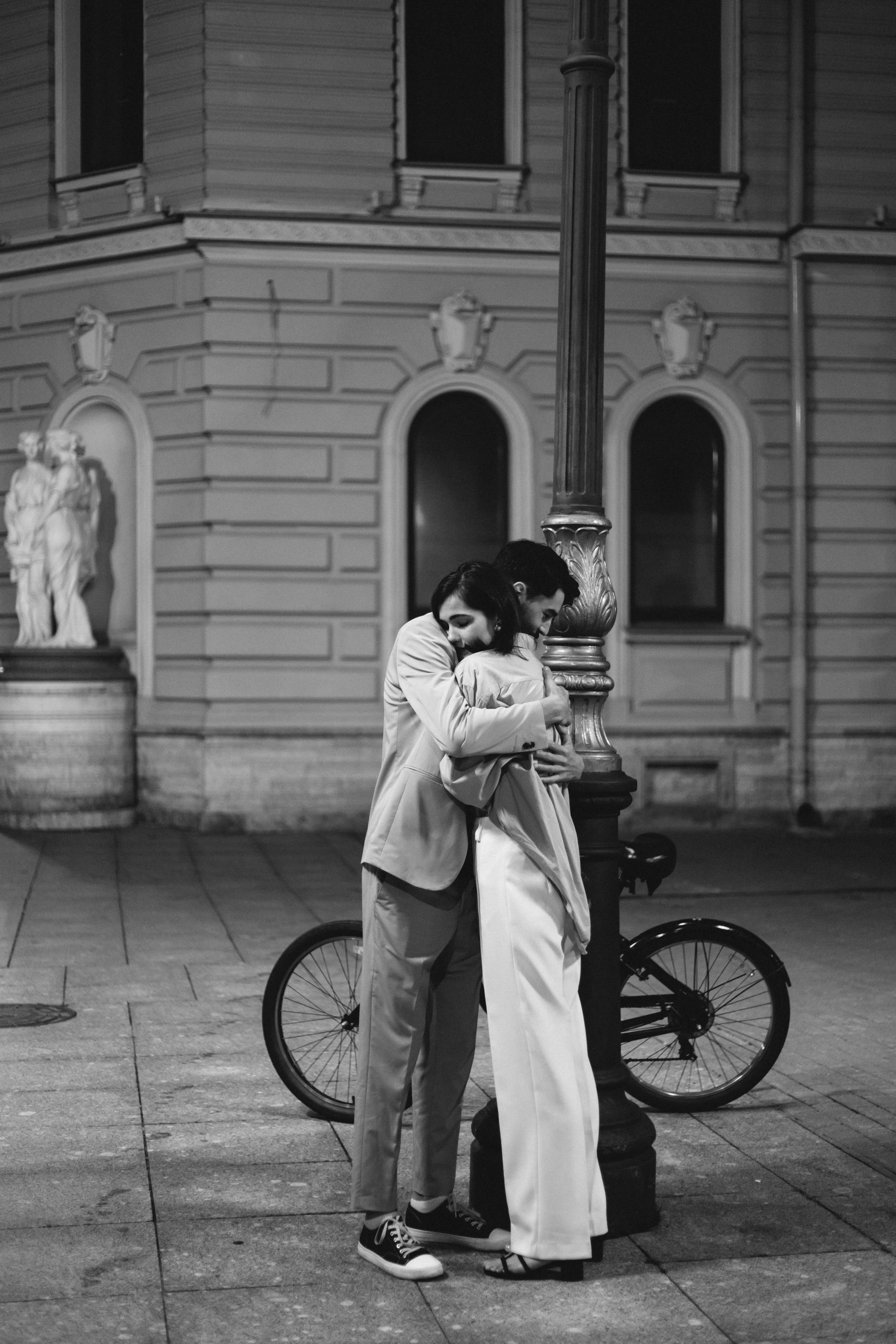 Man and a woman hugging on the street.