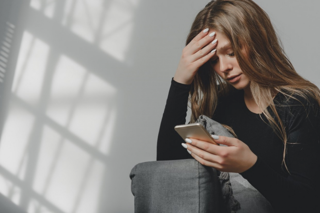 woman looking at smartphone