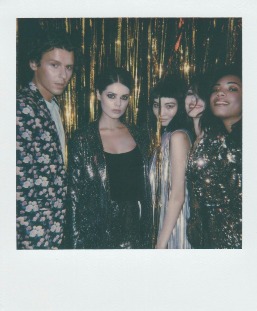 A group of people in glitter clothes at a party.